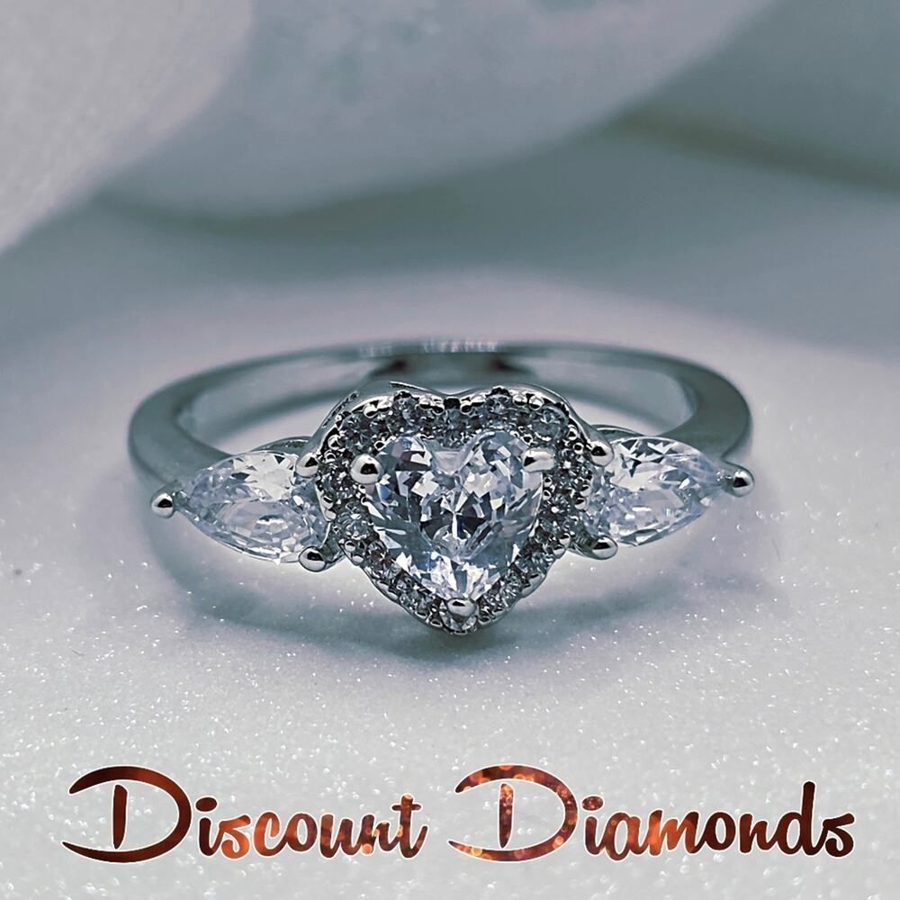 White Heart Shaped Diamond Ring Flanked by 2 Diamonds &  Baguette Diamonds & 925